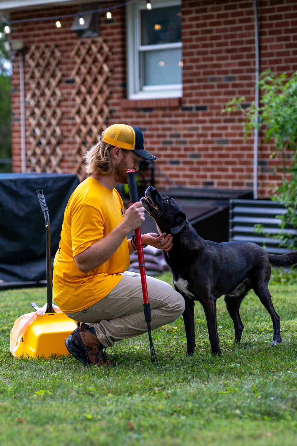 Greg from Northeast Scoopers with a happy dog during a cleanup
